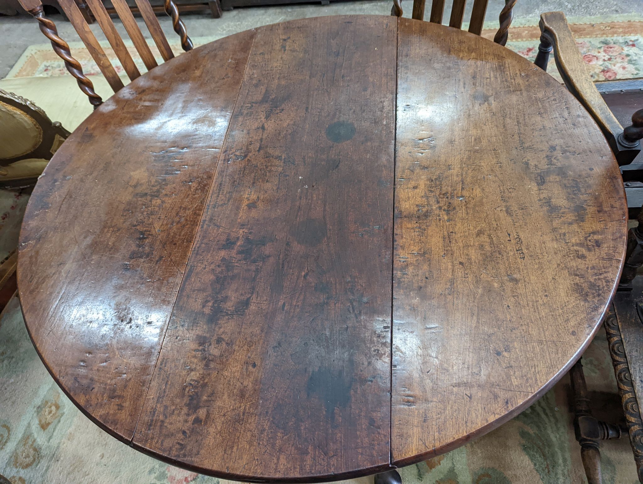 A George III mahogany oval pad foot drop leaf dining table, width 118cm, length 130cm extended, height 71cm